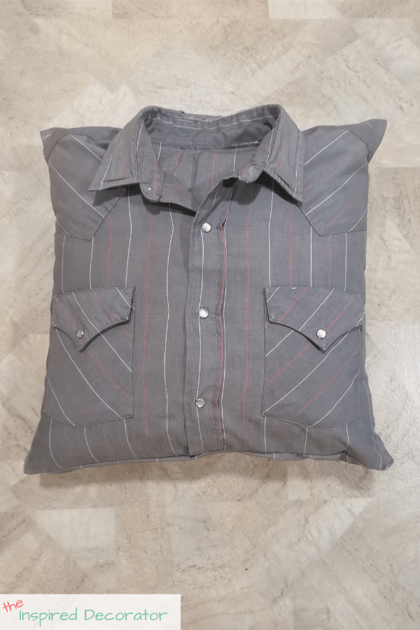 The grey pinstripe shirt was turned into a memory pillow and is complete with a covering for the pillow insert. The insert can be easily removed yet looks like a complete shirt.